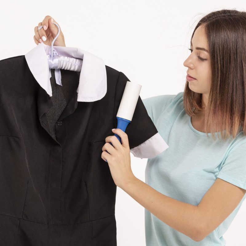medium-shot-woman-using-lint-roller